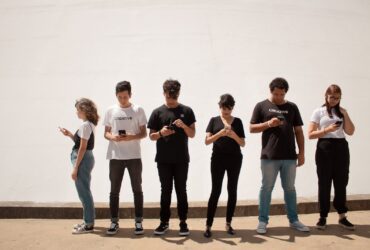 group of people standing on brown floor